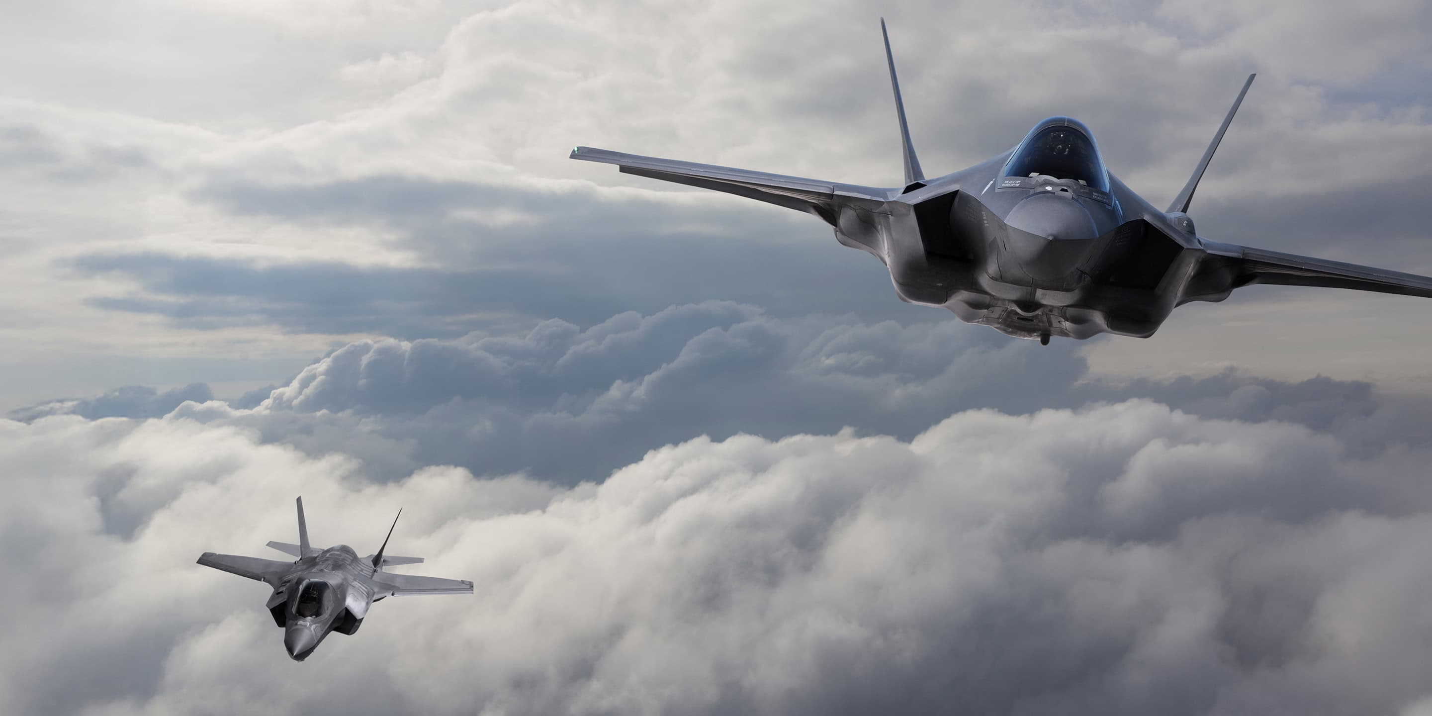 Pair of F-18 Hornet aircraft soaring through the sky in synchronized flight Pair of F-18 Hornet aircraft soaring through the sky in synchronized flight