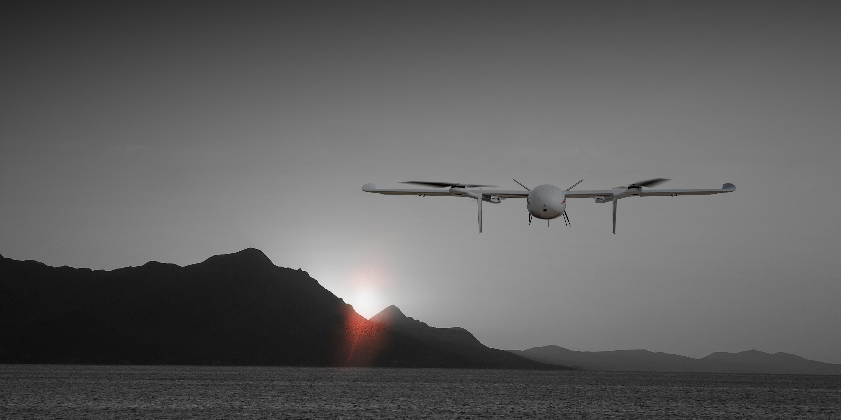 eVTOL in flight approaching a mountainous landscape under clear skies